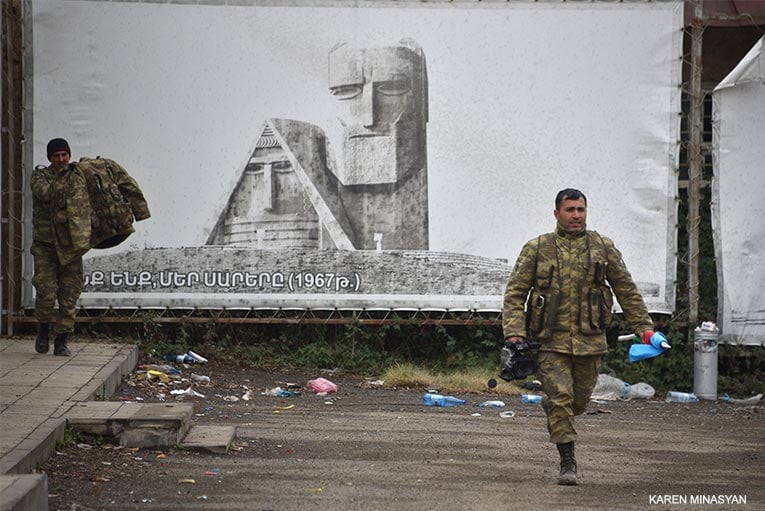 Azerbaijani soldiers make a quick stop in Lachin to take a few pics, then leave.  Karen Minasyan/AFP