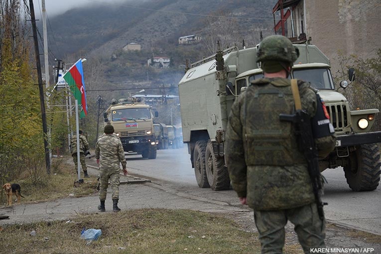 Azerbaijani soldiers make a quick stop in Lachin to take a few pics, then leave.  Karen Minasyan/AFP