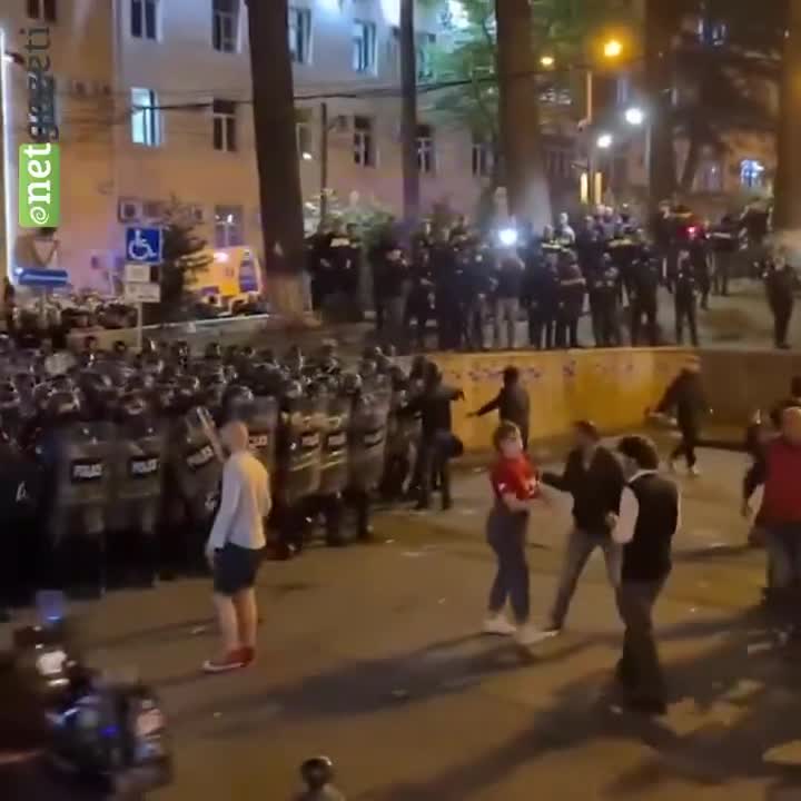Tbilisi: Police grabs and absorbs a protester into the riot police crowd