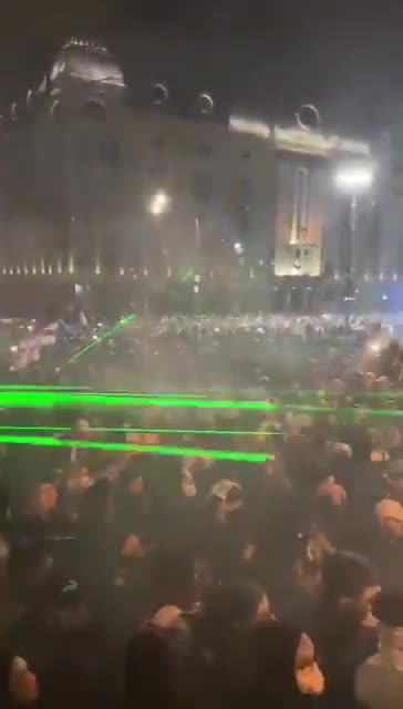 Standoff between riot police and protesters near the parliament continues. The street lights have been switched off. Police regularly use pepper spray and throw gas canisters. People are chanting: Sakartvelo. (Georgia.)